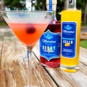 Berry Gin Kiss cocktail in a martini glass garnished with a berry